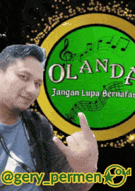 a man is giving the middle finger in front of a green logo that says landa