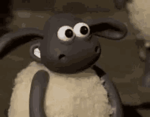 a cartoon sheep with big eyes is holding a knife .