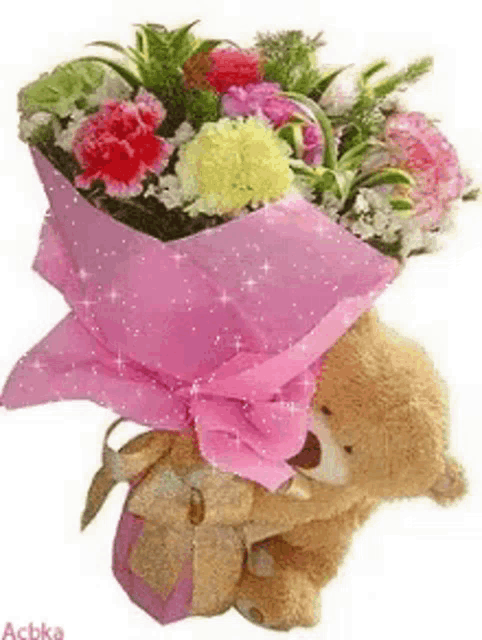 a teddy bear is sitting next to a bouquet of flowers wrapped in pink paper .