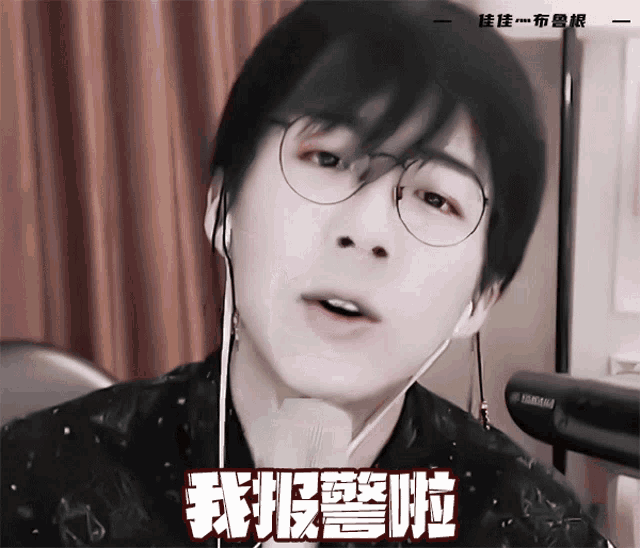a close up of a person wearing glasses and ear buds with a yamaha keyboard in the background