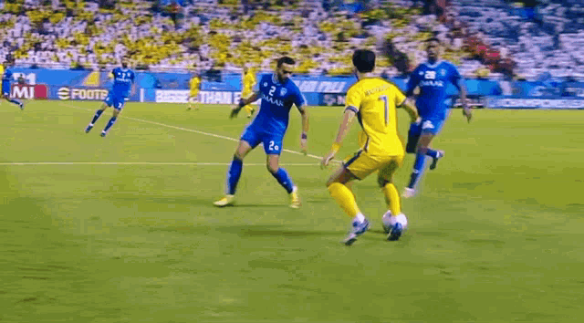 a group of soccer players are playing a game on a field sponsored by neom ..