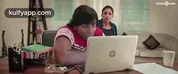 a man is sitting at a table with a laptop computer .