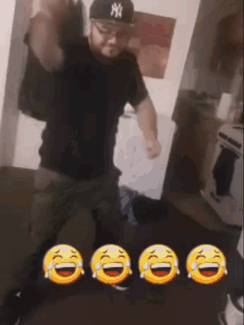 a man wearing a ny hat is kneeling down in a room