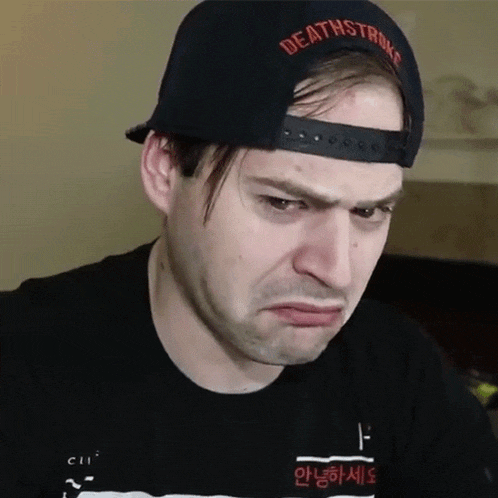 a man wearing a hat that says deathstroke