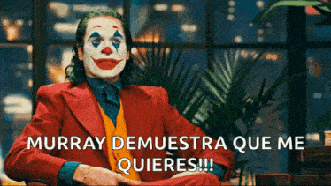 a man in a clown costume is sitting in front of a window and says murray demuestra que me quieres !!!