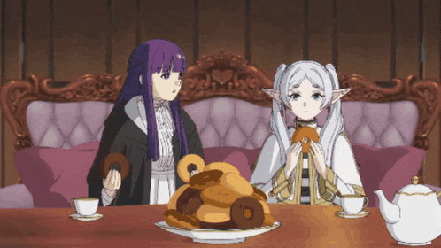 two anime characters sitting at a table with a plate of donuts