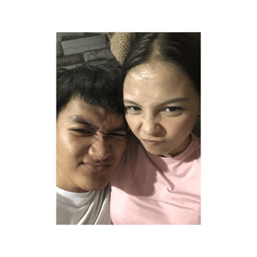 a man and a woman are posing for a picture and the woman is making a funny face