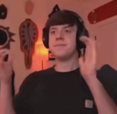 a man wearing headphones is making a funny face in a room .