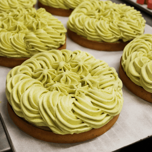 a pastry with green frosting is sitting on a tray