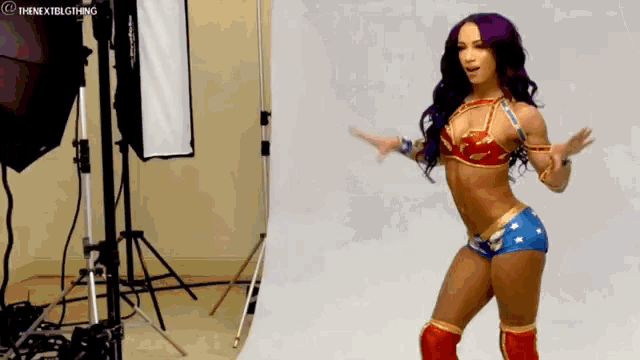 a woman in a wonder woman costume is dancing in a room .
