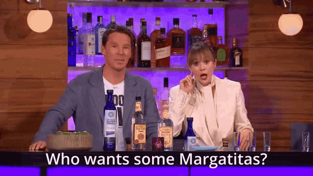 a man and a woman are sitting at a bar with bottles of liquor and the words who wants some margaritas