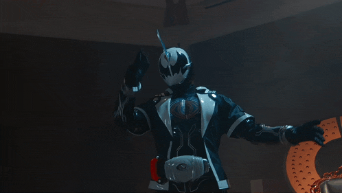 a person in a black and white costume with a light coming out of their chest
