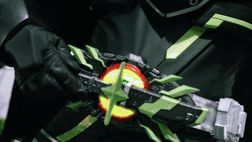 a person is holding a green and black object with a yellow light coming out of it