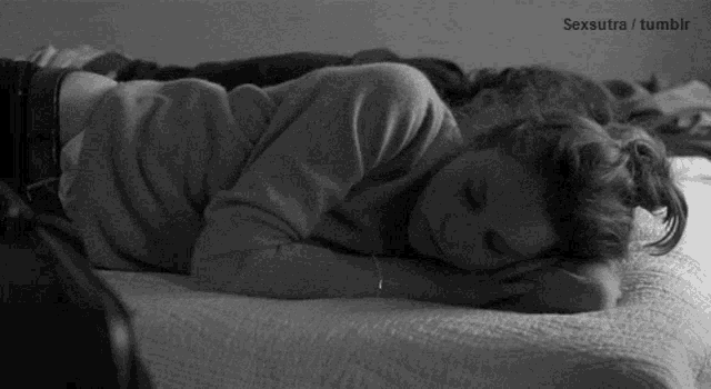 a black and white photo of a woman laying on a bed with the words sexsutra tumblr at the bottom