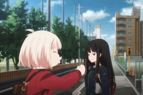 a girl in a red jacket is talking to a girl in a black jacket