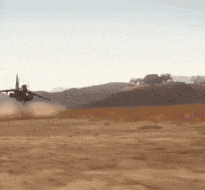 a fighter jet is taking off from a runway in the desert
