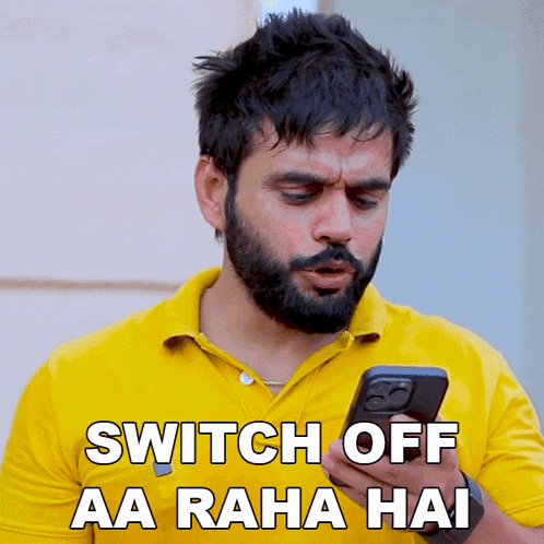 a man in a yellow shirt is holding a cell phone with the words switch off aa raha hai below him