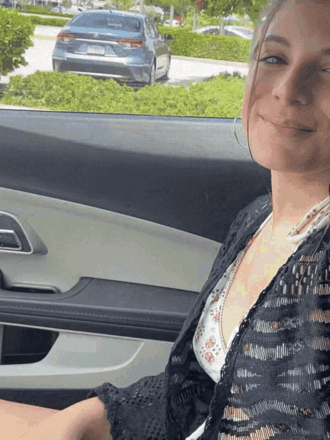a woman is sitting in a car with a license plate that says ' aa ' on it