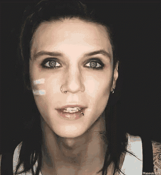 a close up of a person 's face with a nose ring and braces on their teeth .