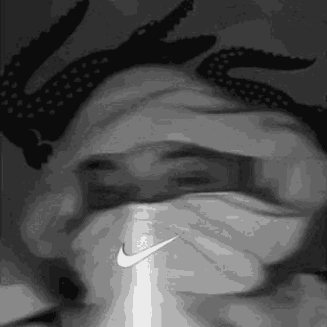 a black and white photo of a person wearing a nike bandana .