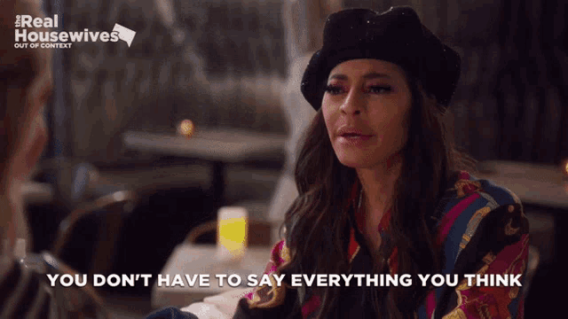 a woman sitting at a table with the words you don 't have to say everything you think