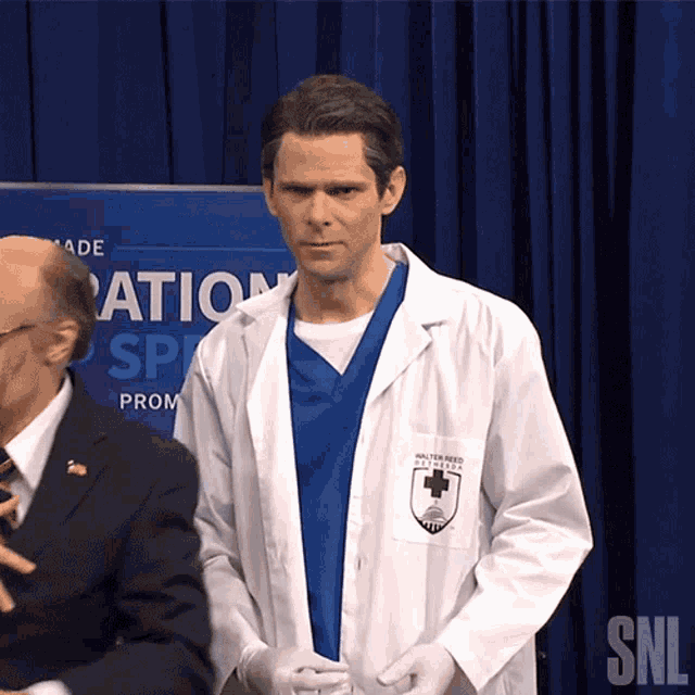 a man in a lab coat with the word snl on the bottom right
