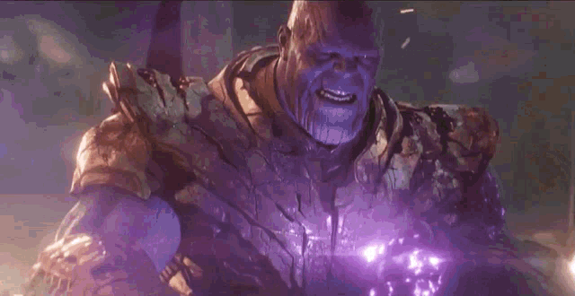 a purple light is coming out of the chest of a superhero .