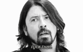 a man with long hair and a beard is saying " fuck that " .