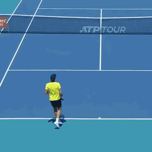 a man is playing tennis on a court with a sign that says atp tour