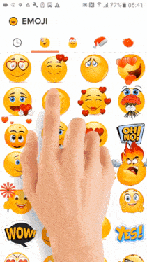 a hand is pointing to an emoji app on a phone screen