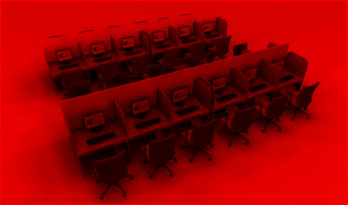 a row of computer cubicles with a red background and a computer on the cubicle