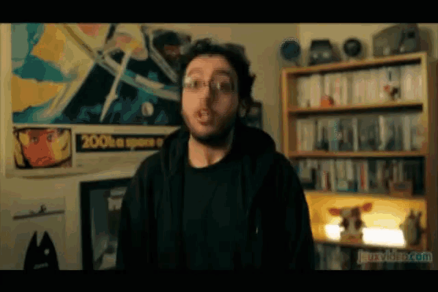 a man is standing in front of a poster that says 200th a space e