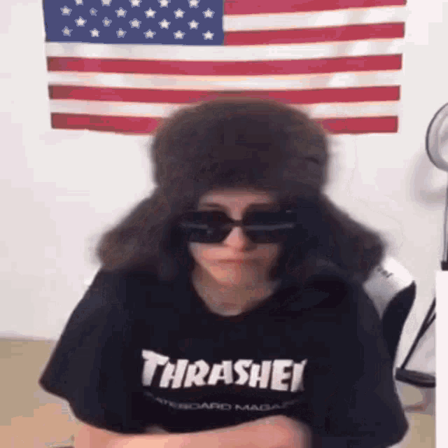 a person wearing a thrasher t-shirt and a fur hat