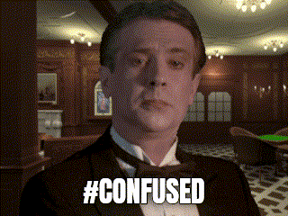 a man in a tuxedo says #confused in front of a room