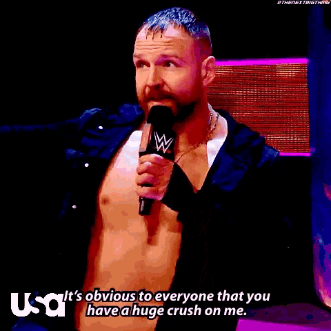 a shirtless wrestler is holding a microphone and saying it 's obvious to everyone that you have a huge crush