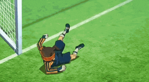 a boy is kicking a soccer ball on a field with chinese writing on it