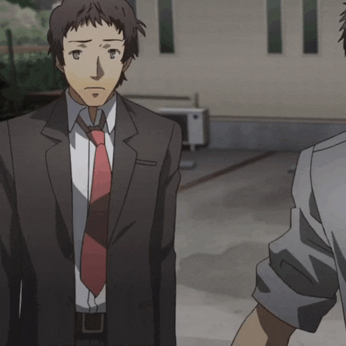 a man in a suit and tie holds another man 's arm