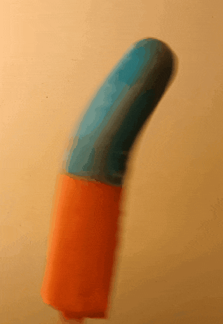 a blue and orange object is moving on a table