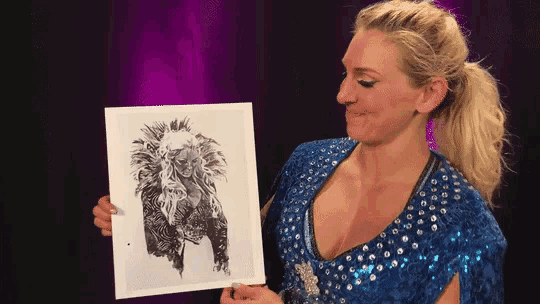 a woman in a blue dress is holding a picture