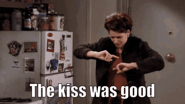 a woman in front of a refrigerator with the words the kiss was good above her