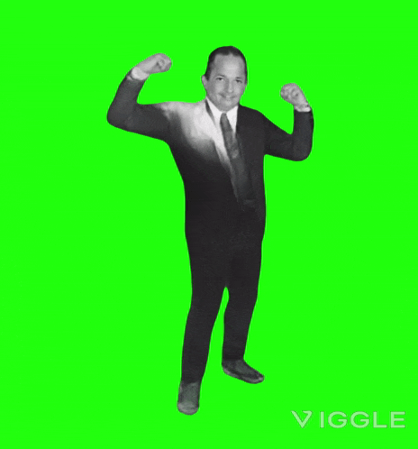 a man in a suit and tie dancing on a green screen