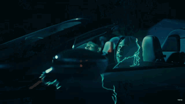 a car is driving down a street while lightning strikes