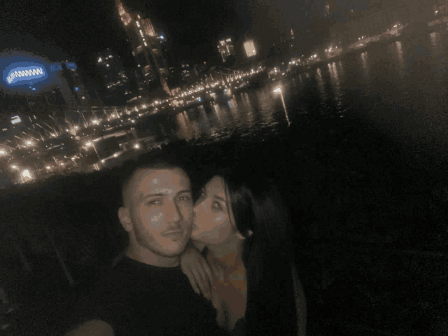a woman kisses a man on the cheek in front of a building that says ' johnson '