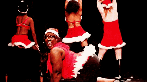 a man in a santa hat is kneeling down on the floor