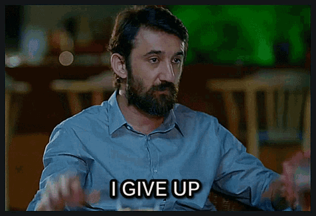 a man with a beard and a ring on his finger says i give up