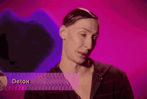 a woman is standing in front of a pink background with the word detox on it .