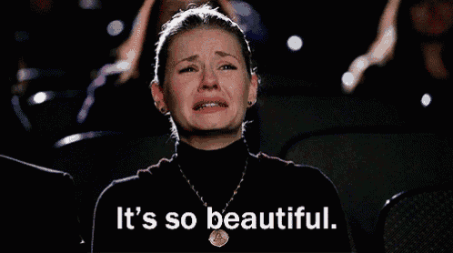 a woman is crying while watching a movie and the words " it 's so beautiful " are written below her