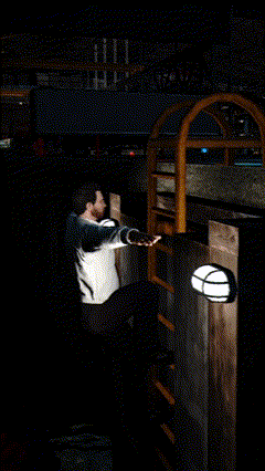 a man is standing in a dark room with a light on the wall