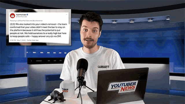 a man is sitting in front of a youtuber news laptop