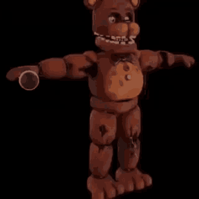 a 3d model of a teddy bear from five nights at freddy 's is standing in the dark .